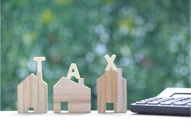 estate tax tax word model house green background business investment property tax concept